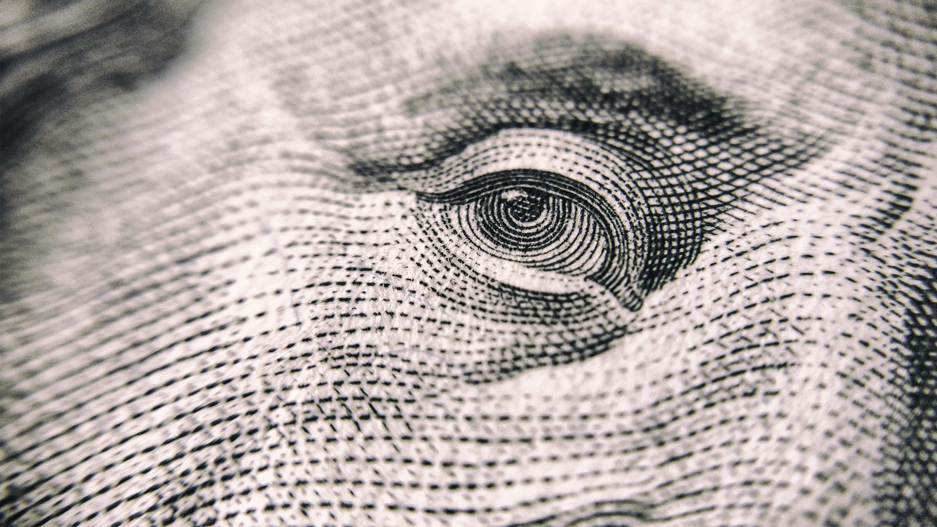 closeup of Benjamin Franklin's eye on an American dollar bill