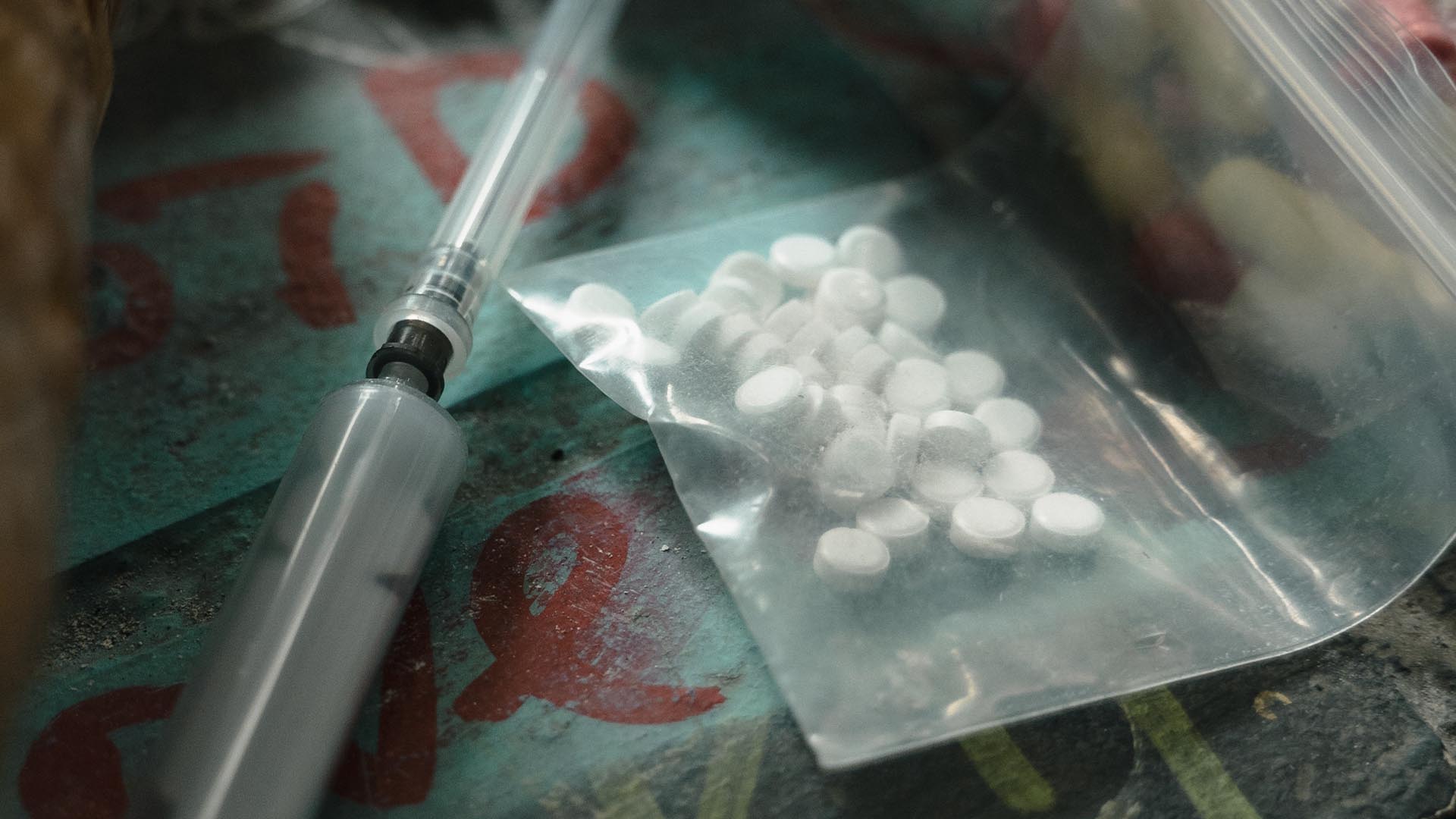 syringe and white pills